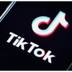 TikTok logo with AI moderation interface showing content safety enforcement in Nigeria.