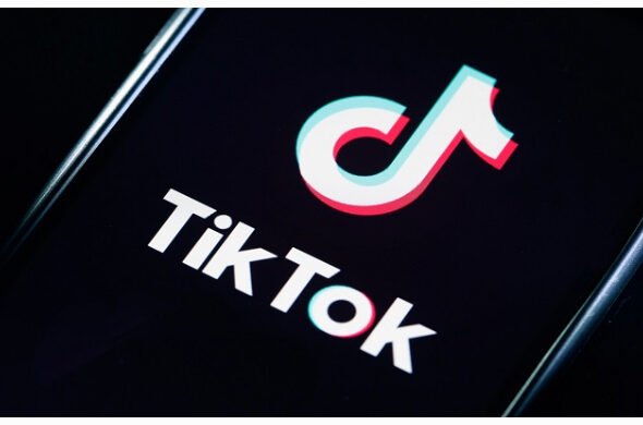 TikTok logo with AI moderation interface showing content safety enforcement in Nigeria.
