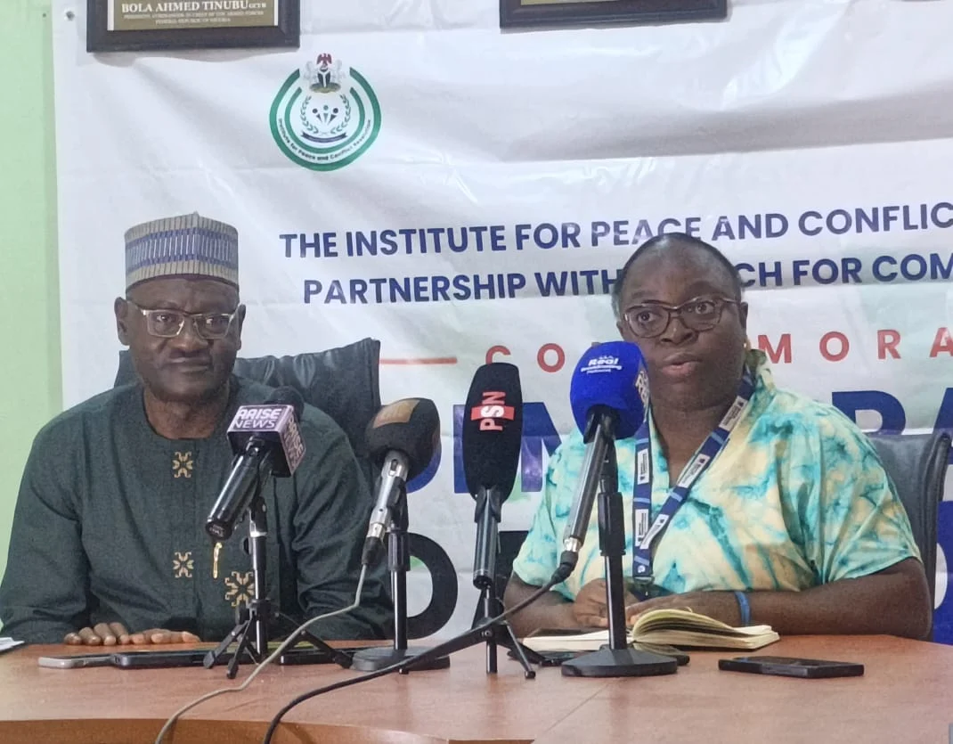 IPCR officials addressing a Democracy Day briefing in Abuja
