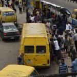 Nigerian workers commuting amid rising transport costs and inflation.