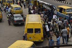 Nigerian workers commuting amid rising transport costs and inflation.