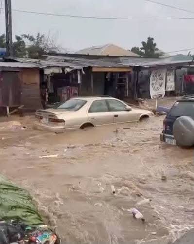 Flooded road in Lagos after heavy rainfall as the state begins dredging additional drainage channels.