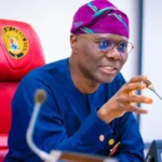 Governor Babajide Sanwo-Olu presenting compensation cheques to affected property owners in Lagos.