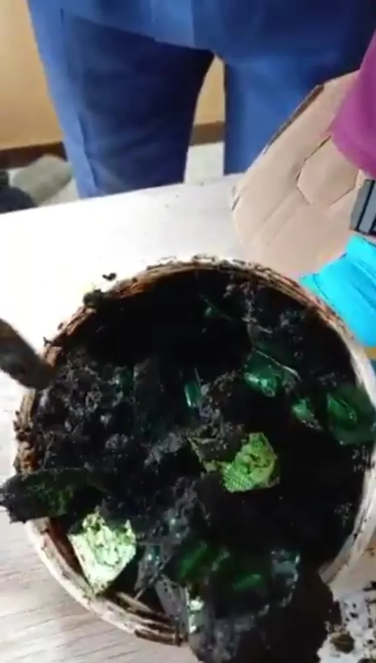 NDLEA officers display tramadol pills concealed inside black soap containers intercepted in Lagos.