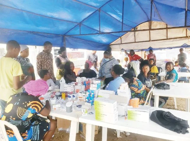 Medical personnel attend to residents during RCCG's free medical outreach in Lagos.