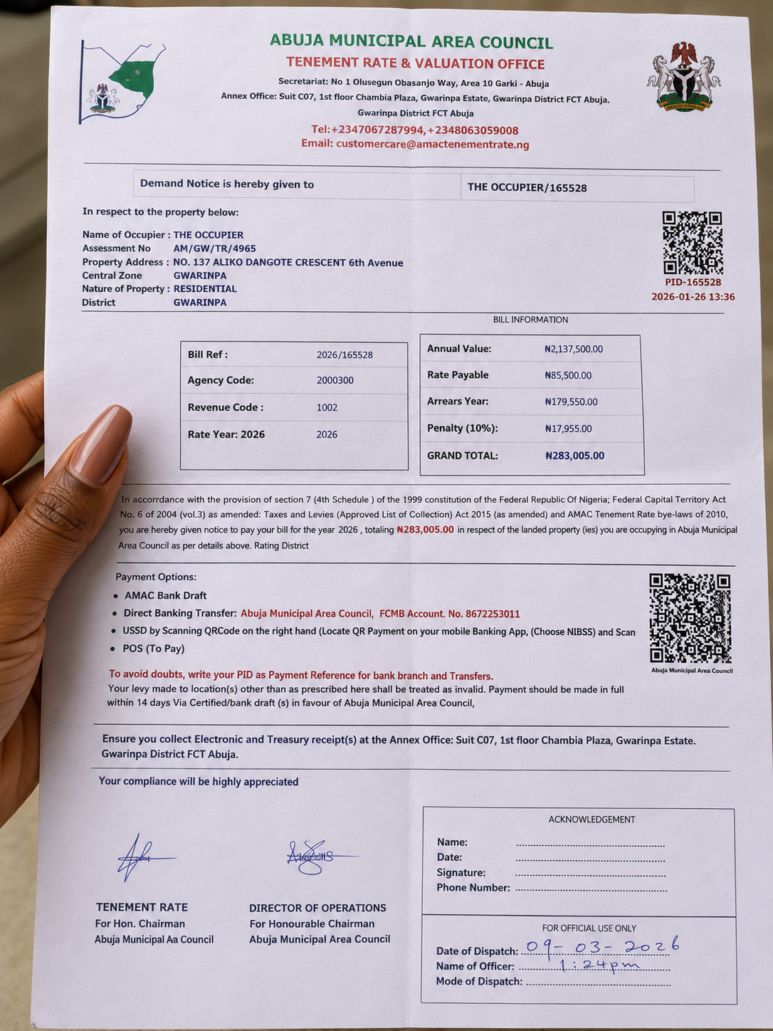 Simbiat Usman displays the Abuja Municipal Area Council (AMAC) tenement rate demand notice issued to her property in Abuja. (Photo: Mirian/AHR)
