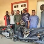 NSCDC operatives display items recovered during a motorcycle theft investigation in Kano