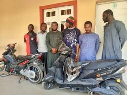 NSCDC operatives display items recovered during a motorcycle theft investigation in Kano