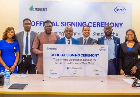 Representatives of Roche Diagnostics and MedServe sign a healthcare partnership agreement in Lagos.