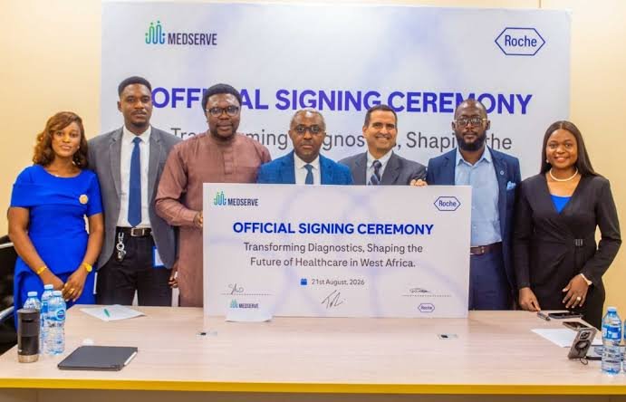 Representatives of Roche Diagnostics and MedServe sign a healthcare partnership agreement in Lagos.