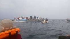 Rescue teams conduct search operations after a ferry capsizes on Lake Kariba.
