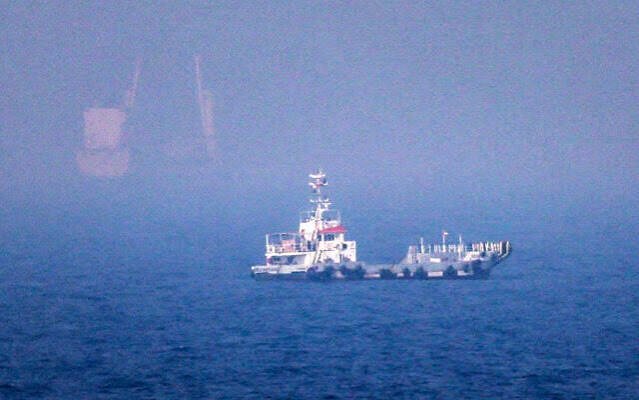 Oil tanker sails through the Strait of Hormuz amid escalating US-Iran military tensions.