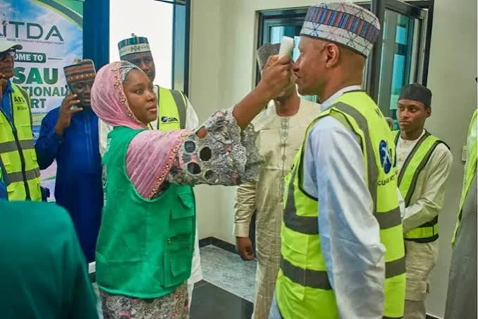 Health personnel conduct passenger screening as Zamfara State strengthens surveillance against Ebola.