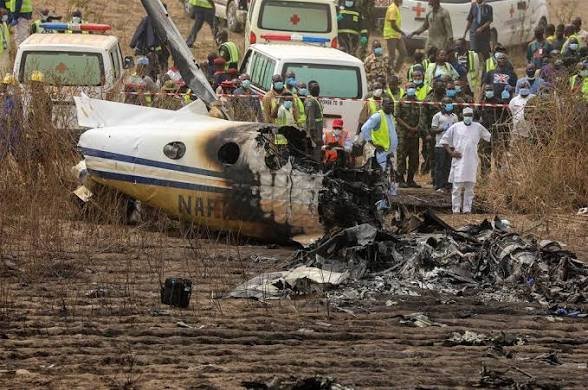 Rescue teams gather near the reported site of a military aircraft crash in Igbokoda, Ondo State.