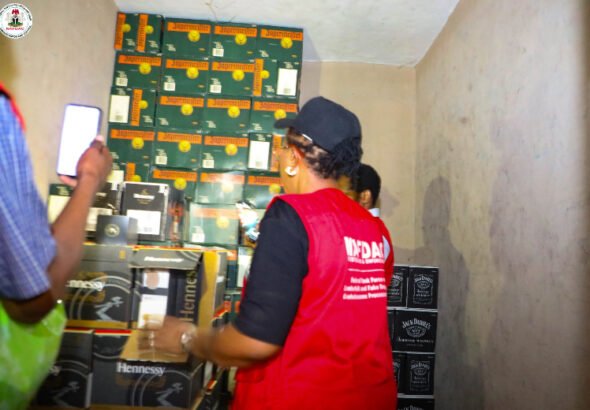 NAFDAC enforcement operation at the Lagos International Trade Fair Complex where suspected counterfeit alcoholic beverages and prohibited products were seized.